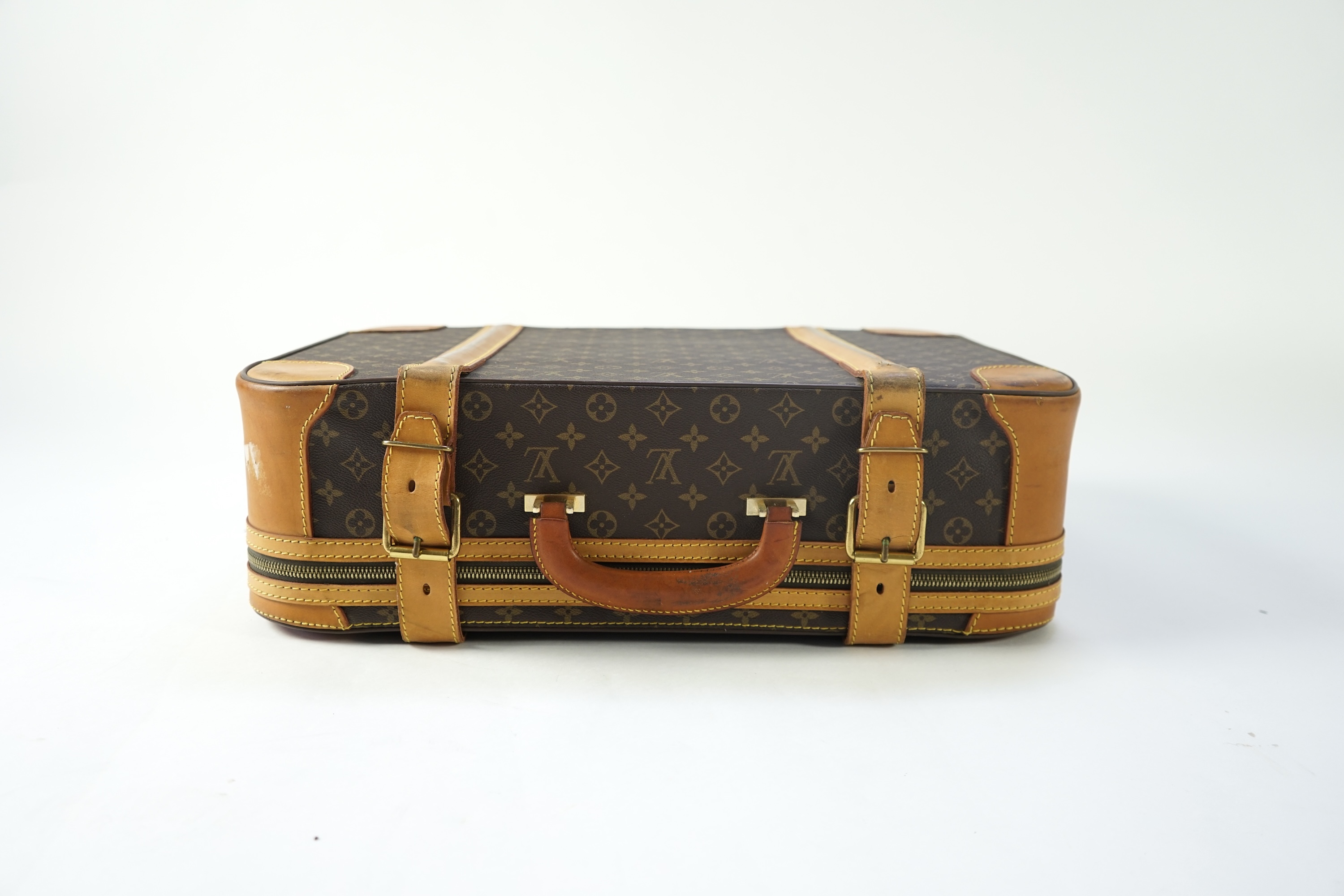 A Louis Vuitton monogrammed canvas with leather trim soft sided suitcase